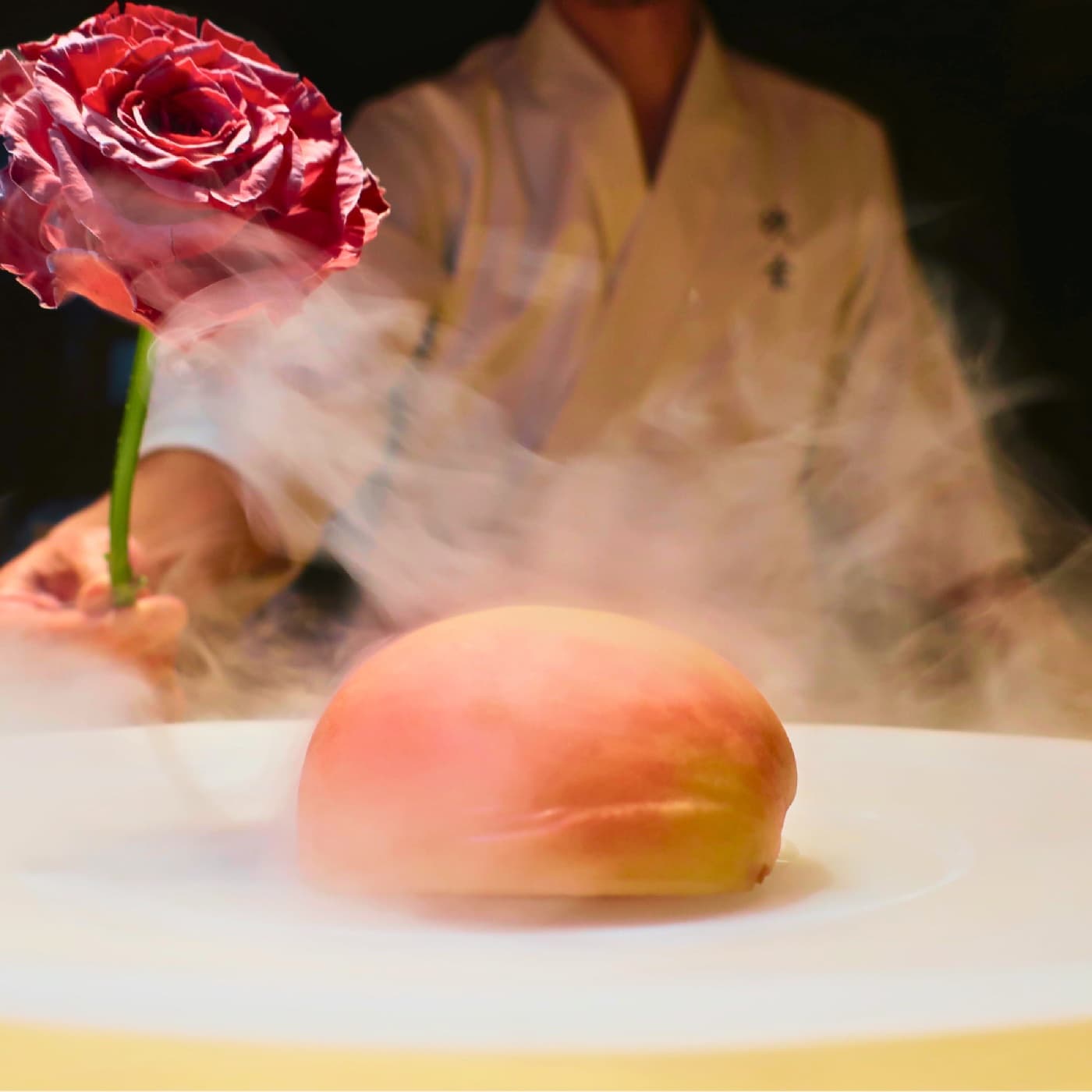 A theatrical seasonal dessert presentation with a rose