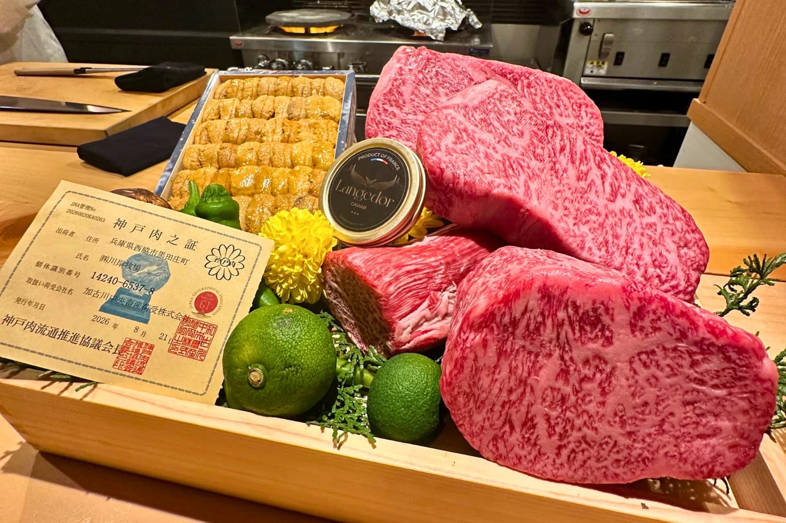 Certified Kobe beef steaks with uni and caviar, presented in a wooden box at the counter